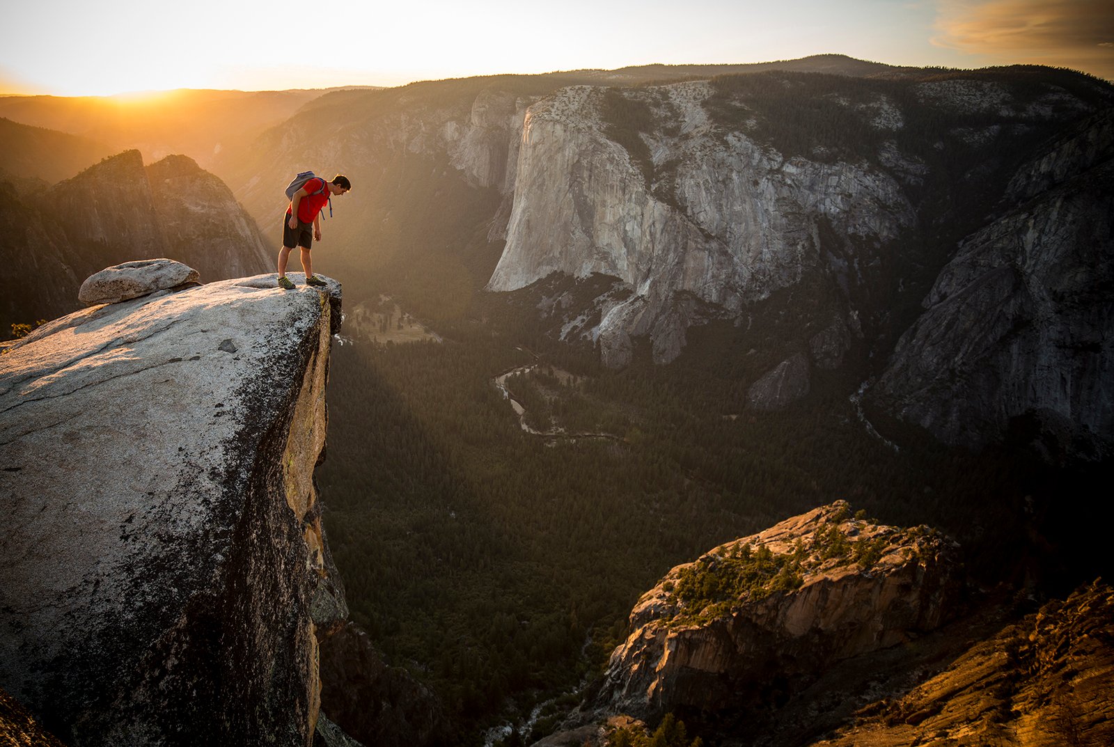 Alex Honnold peering down Taft Point, Yosemite, California